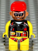 Duplo Figure, Male Action Wheeler, Yellow Legs, Yellow Top with Yellow/Black/Red Parachute, Red Cap, Beard, Sunglasses and Headphone 