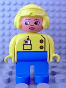 Duplo Figure, Female, Blue Legs, Yellow Top with Radio in Pocket, Yellow Aviator Helmet, Eyelashes 