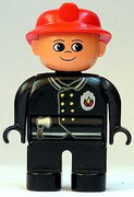 Duplo Figure, Male Fireman, Black Legs, Black Top with Flame Logo, Red Fire Helmet, no Moustache 