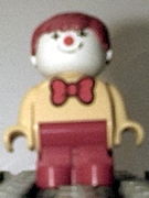 Duplo Figure, Child Type 1 Boy, Red Legs, Yellow Top With Red Bow Tie, Red Hair (Clown) 