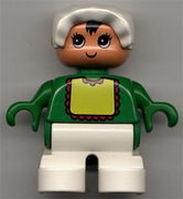 Duplo Figure, Child Type 2 Baby, White Legs, Green Top with Yellow Bib with Red Lace, White Bonnet 