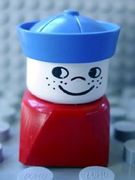 Duplo 2 x 2 x 2 Figure Brick Early, Male on Red Base, Blue Sailor Hat, Freckles 